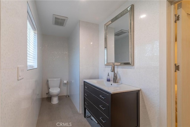 bathroom featuring tile patterned flooring, vanity, and toilet