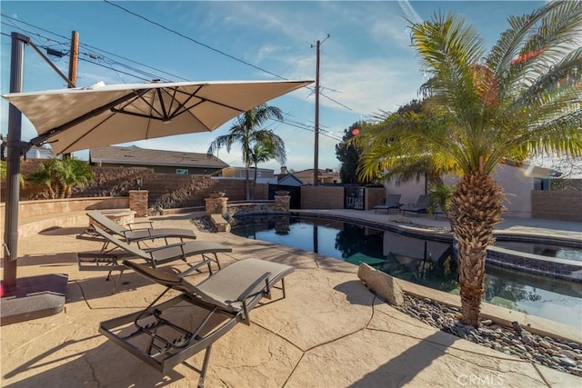 view of swimming pool with an in ground hot tub, area for grilling, and a patio area