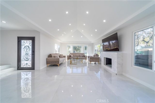 unfurnished living room with a fireplace and high vaulted ceiling