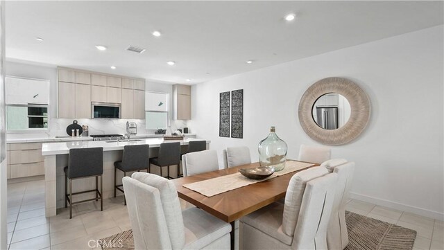 tiled dining area featuring sink