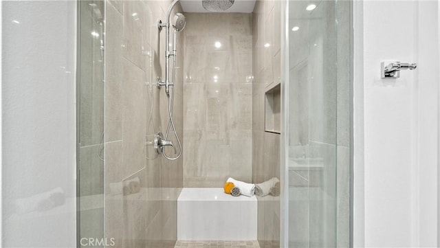 bathroom with a shower with shower door