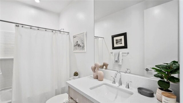 full bathroom with vanity, toilet, and shower / tub combo with curtain