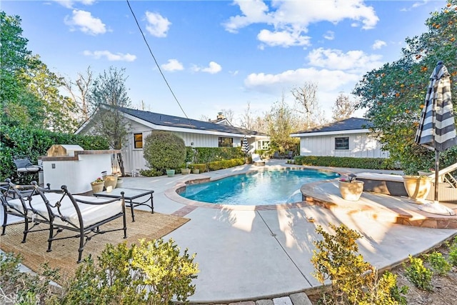 view of swimming pool with a hot tub and a patio area