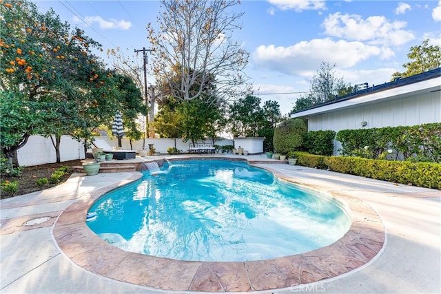 view of pool with a patio and pool water feature