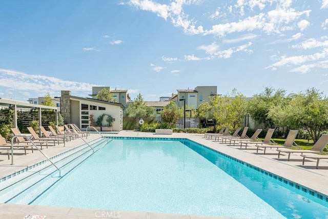 community pool featuring a patio area and fence