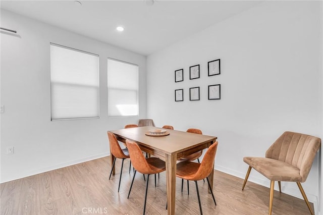 dining area featuring light wood-style floors, baseboards, and recessed lighting