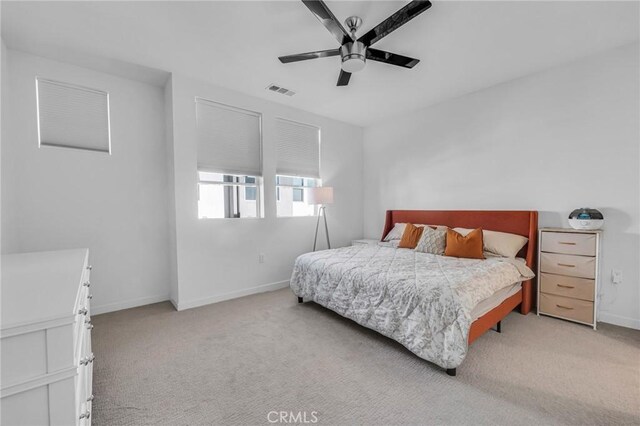 bedroom with light carpet and ceiling fan