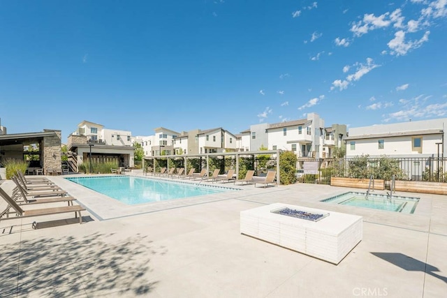 pool featuring a fire pit, a residential view, fence, a community hot tub, and a patio area