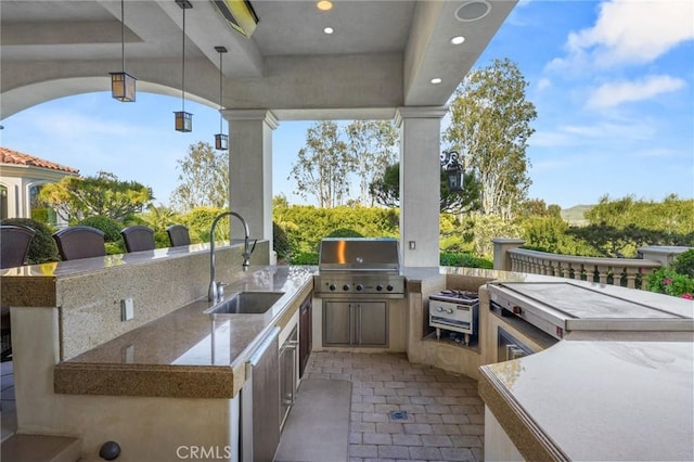 view of patio / terrace with a grill, exterior kitchen, and sink