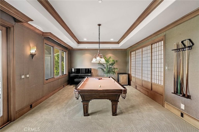 rec room with billiards, a tray ceiling, ornamental molding, and light colored carpet