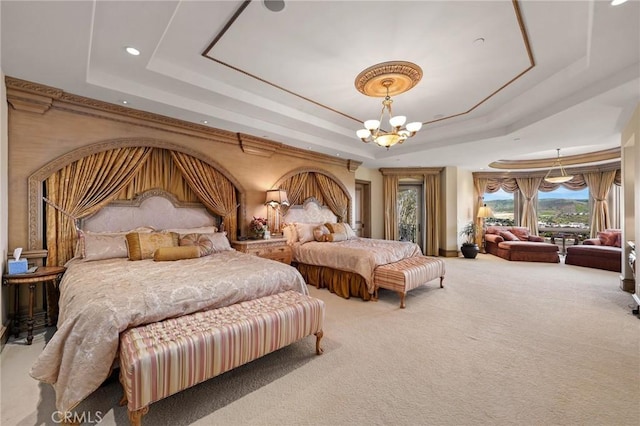 bedroom featuring carpet, a chandelier, and a tray ceiling