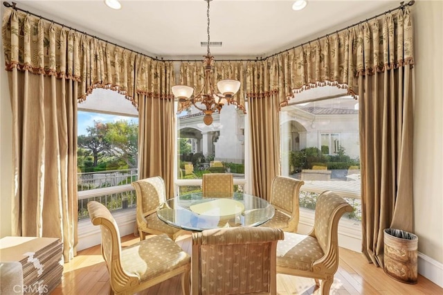 dining room featuring a chandelier and light wood-type flooring