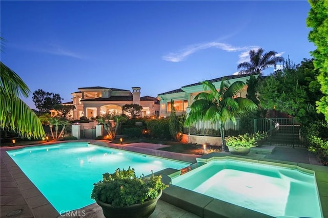 view of swimming pool featuring an in ground hot tub