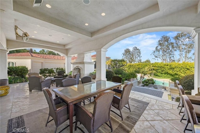 view of patio featuring exterior fireplace