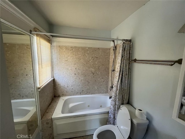 bathroom featuring shower / bathtub combination with curtain and toilet