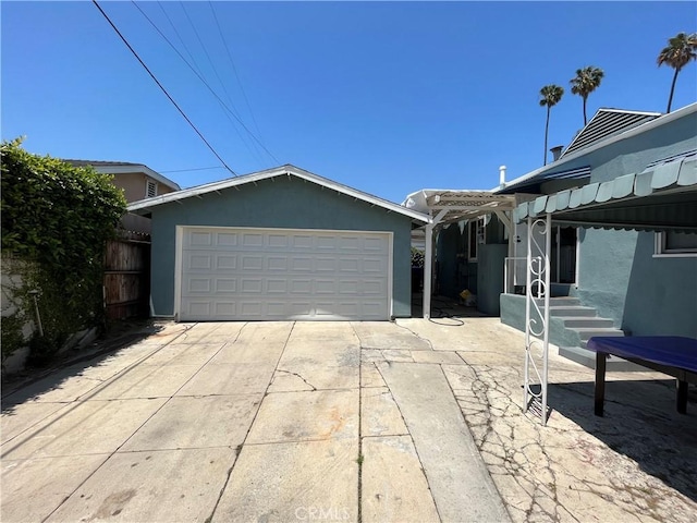 view of front of property with a garage and an outdoor structure