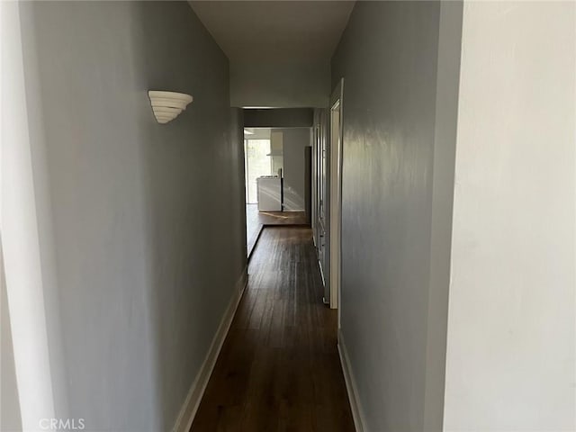 hallway featuring washing machine and dryer and dark hardwood / wood-style flooring