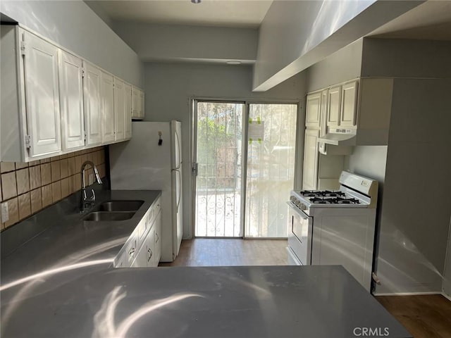 kitchen featuring sink, white appliances, light hardwood / wood-style floors, and white cabinets