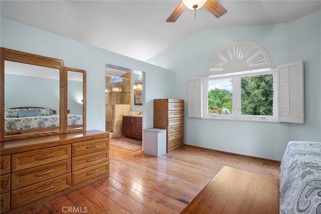 bedroom featuring ensuite bathroom, vaulted ceiling, ceiling fan, and light hardwood / wood-style flooring