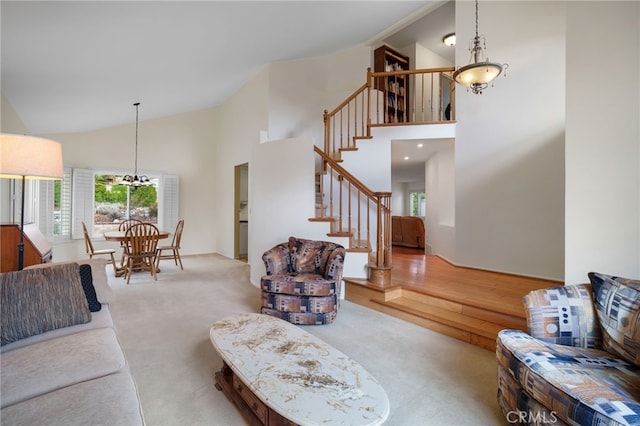 carpeted living room with high vaulted ceiling