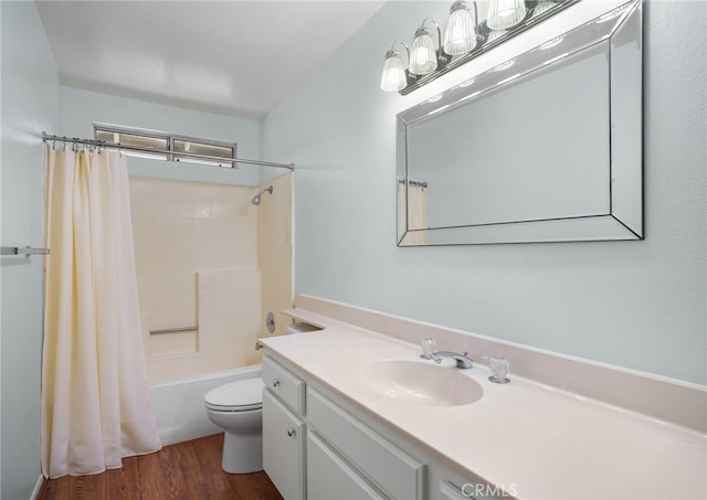 full bathroom featuring shower / tub combo, vanity, wood-type flooring, and toilet