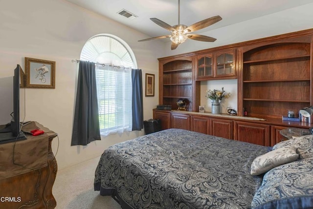 bedroom featuring light colored carpet and ceiling fan