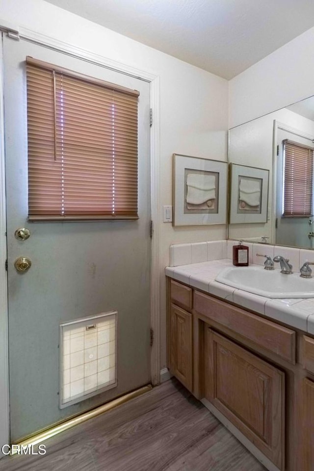 bathroom featuring hardwood / wood-style flooring and vanity