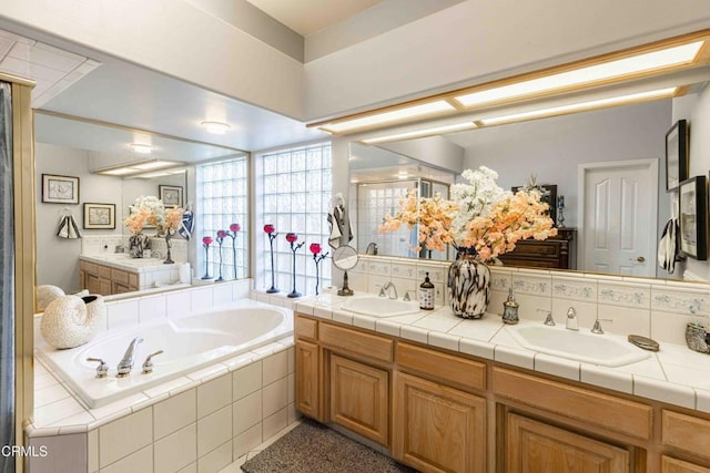 bathroom featuring vanity, separate shower and tub, and decorative backsplash