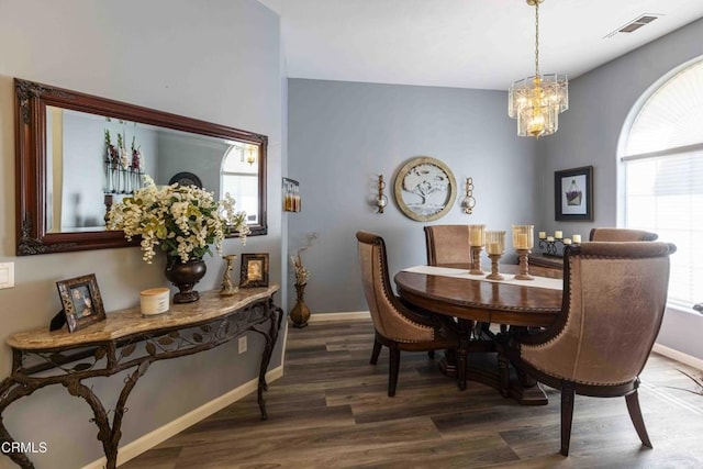 dining area featuring an inviting chandelier and hardwood / wood-style floors