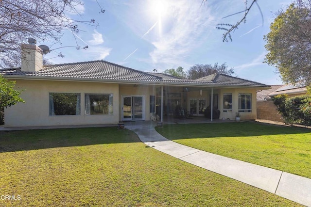 back of house featuring a yard and a patio