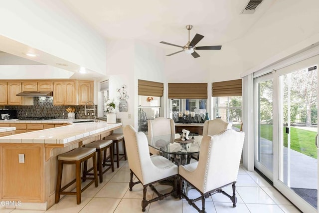 tiled dining area featuring sink and ceiling fan