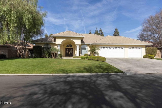 view of front of home featuring a garage and a front yard