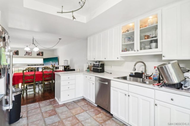 kitchen featuring sink, dishwasher, kitchen peninsula, white cabinets, and a raised ceiling