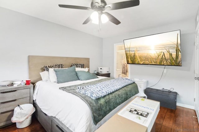 bedroom featuring dark hardwood / wood-style floors, ceiling fan, and ensuite bathroom