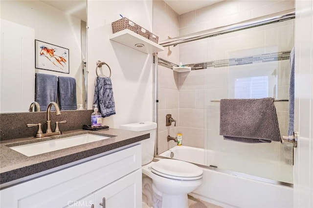 full bathroom with toilet, vanity, and shower / bath combination with glass door