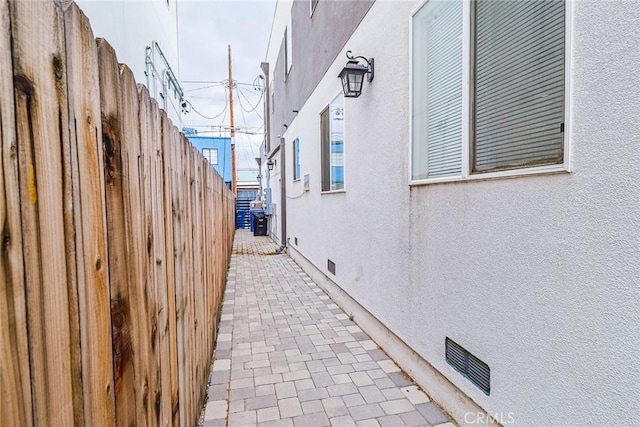 view of property exterior with a patio area