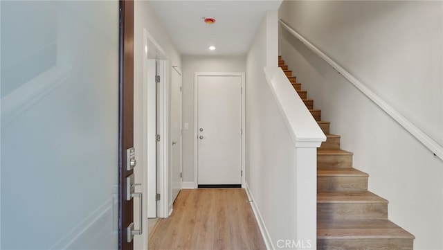 stairs featuring hardwood / wood-style floors