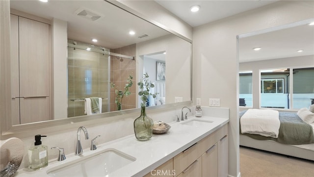 bathroom featuring vanity and an enclosed shower