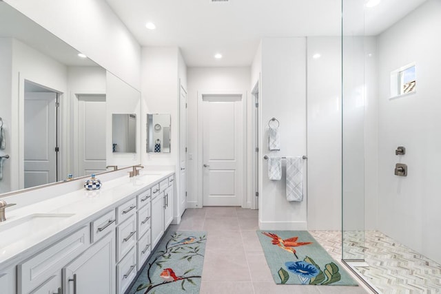 bathroom with tile patterned floors, vanity, and a shower