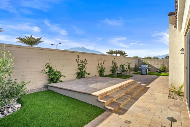 view of yard featuring a mountain view and a patio area