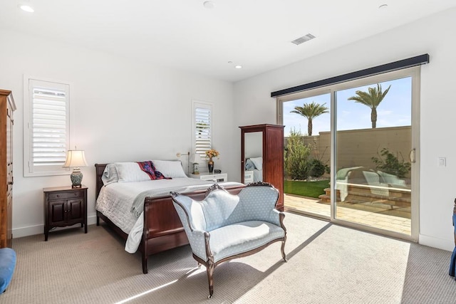 bedroom featuring multiple windows, access to exterior, and light colored carpet