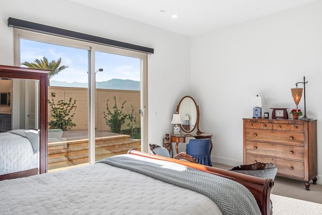 carpeted bedroom with access to exterior and a mountain view