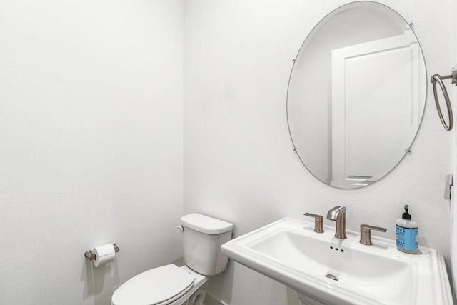 bathroom with sink and toilet