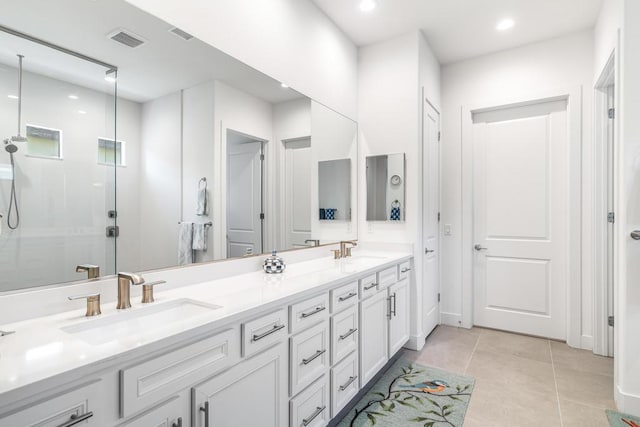 bathroom featuring tile patterned floors, vanity, and a shower