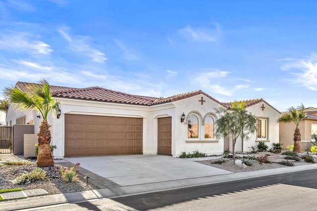 mediterranean / spanish-style house with a garage