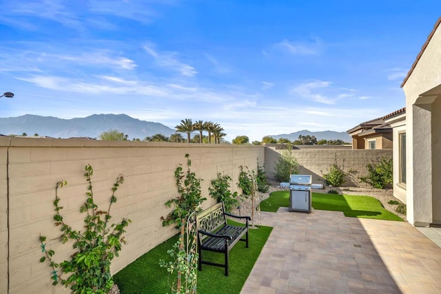 view of patio featuring grilling area and a mountain view