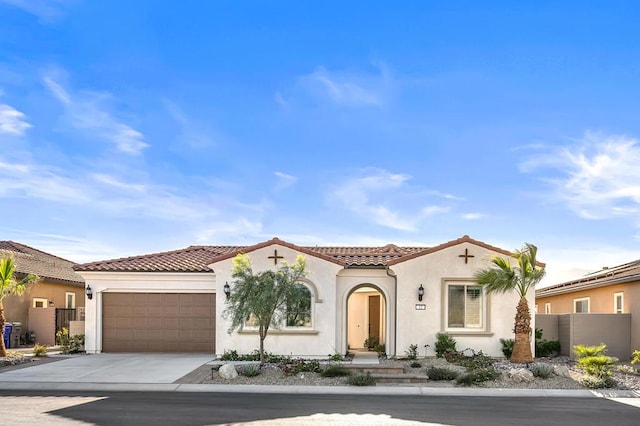 mediterranean / spanish-style home with a garage