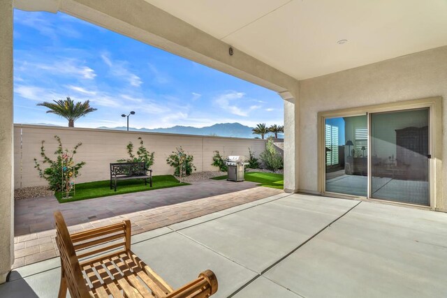 view of patio with a mountain view and grilling area