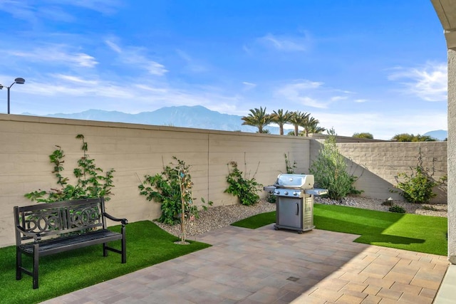 view of patio / terrace featuring area for grilling and a mountain view