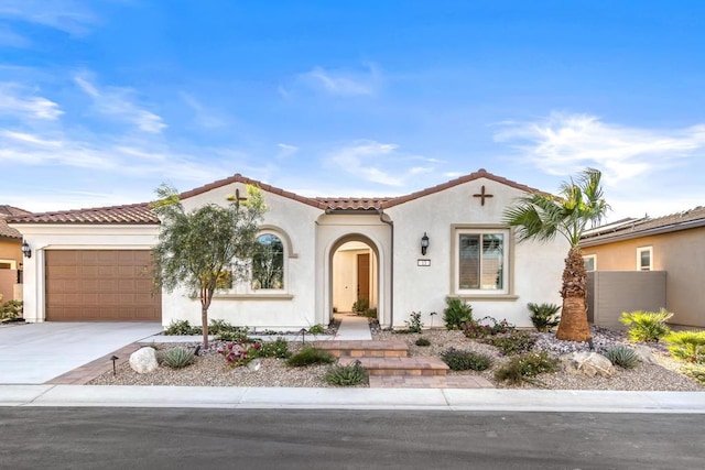 mediterranean / spanish house with a garage